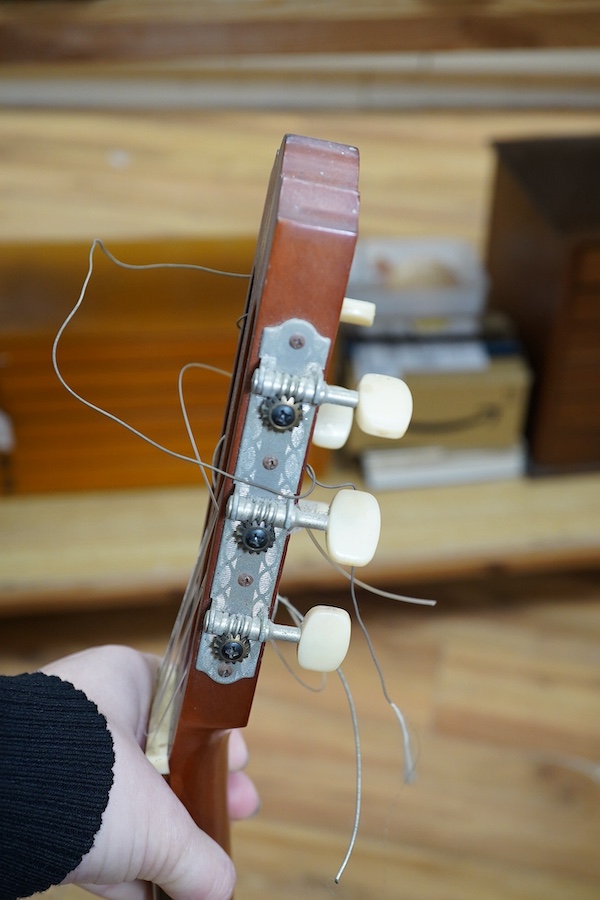 A Suzuki classical guitar, no.3067. Condition - fair, one string missing and scratches to the body.